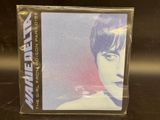 a close up of a cd case with a woman ' s face on it