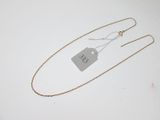 a close up of a gold chain with a tag on it