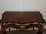 a small table with a red and gold design on it
