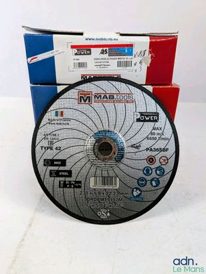 a close up of a disc on a table next to a box