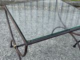 a glass table with a metal frame and a glass top