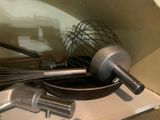 a whisk and a whisk in a bowl on top of a stove