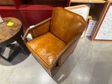 brown leather chair and side table in a room with red walls