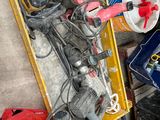 a box full of assorted tools on the floor