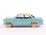 a blue toy car with a white top on a white surface