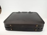 a brown suitcase sitting on a white table