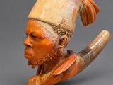 a close up of a figurine of a man with a pipe