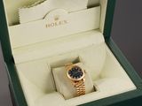 a rolex watch in a box on a table