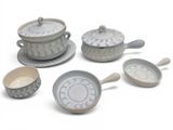 a set of five bowls and saucers with spoons on them