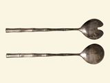 two spoons that are sitting next to each other