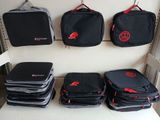 several pieces of luggage sitting on top of a shelf next to each other