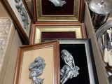 three framed pictures of a woman in a headdress are on display in a box