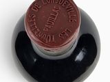 a bottle of wine with a red label on it