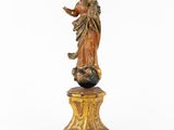 an antique statue of a woman holding a child on a pedestal