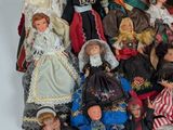 a lot of dolls that are sitting together on a table