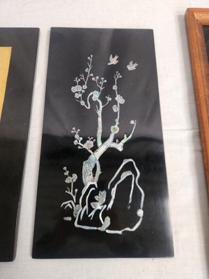 three framed pictures on a table with a picture of a tree