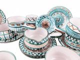many cups and saucers that are sitting on the table