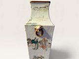 a white vase with a handle on it on a white surface