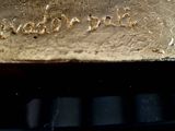 a close up of a piece of metal with writing on it