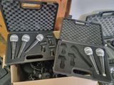 four microphones in a case sitting on a table
