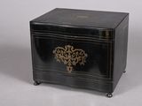 a small black box with a gold design on it