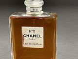 chanel no 5 perfume bottle on a grey surface
