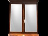 a wooden desk with a mirror on top of it in front of a black background