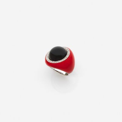 a close up of a red and black ring on a white surface