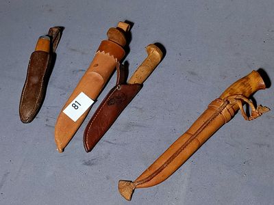 several different types of knives are lined up on a table
