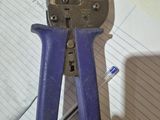 purple pliers on top of a piece of paper on a table