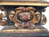 a close up of a gold and black vase with a coat of arms on it
