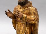 an old wooden statue of a man with a beard and a robe