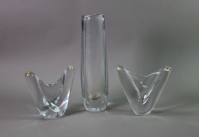 three glass vases sitting next to each other on a table