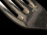 a close up of a fork on a black background