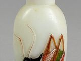 a small glass bottle with a painting of a bug on it