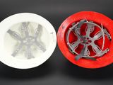 a red and white object in the middle of a white bowl