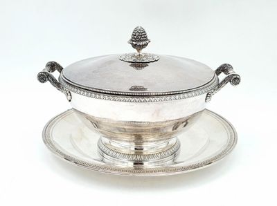 a silver plate with a bowl on it on a saucer