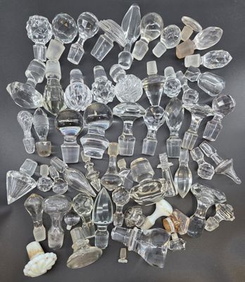 a pile of clear glass pieces sitting on top of a black surface