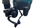 un appareil photo, un téléphone portable et un sac pour appareil photo sur fond blanc