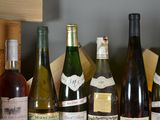 several bottles of wine are lined up on a shelf in a wine cellar