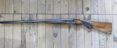 a rifle that is laying on a wooden floor
