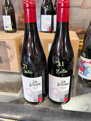 several bottles of wine are on a counter in a store