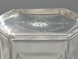 a silver vase with a silver lid on a table