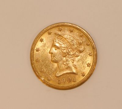 a close up of a gold coin with a woman ' s head on it