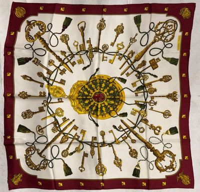 a close up of a square scarf with a bunch of keys on it