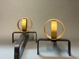 two gold rings on a black stand on a gray background