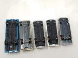four different model trains sitting side by side on a table