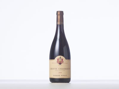 a bottle of red wine sitting on top of a table