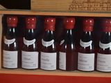 bottles of red wine in a wooden box on a table