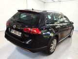 the back end of a black vw golf wagon parked in a garage